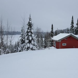 cabin covered in winter snow